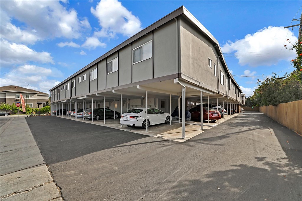a parking lot with cars parked in front of a building