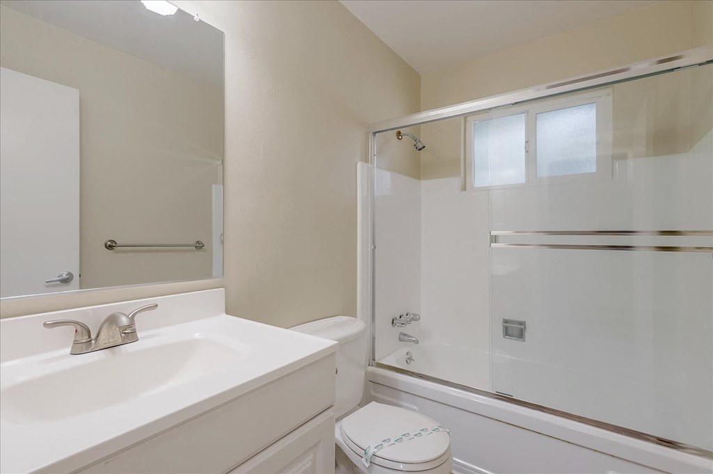 a bathroom with a sink toilet and a shower