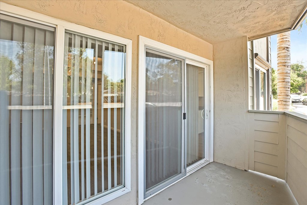 A patio with a sliding glass door and a window.