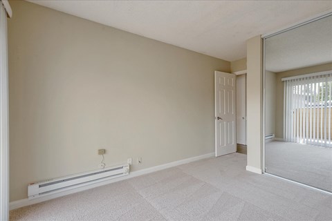 the living room with a door to a balcony