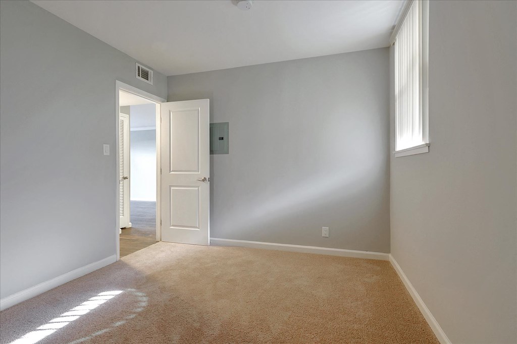 a empty room with a door open to a hallway