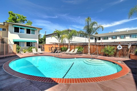 a swimming pool with a house in the background