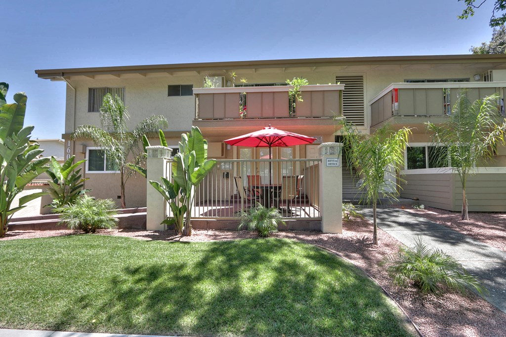 A building with a red umbrella in front of it.