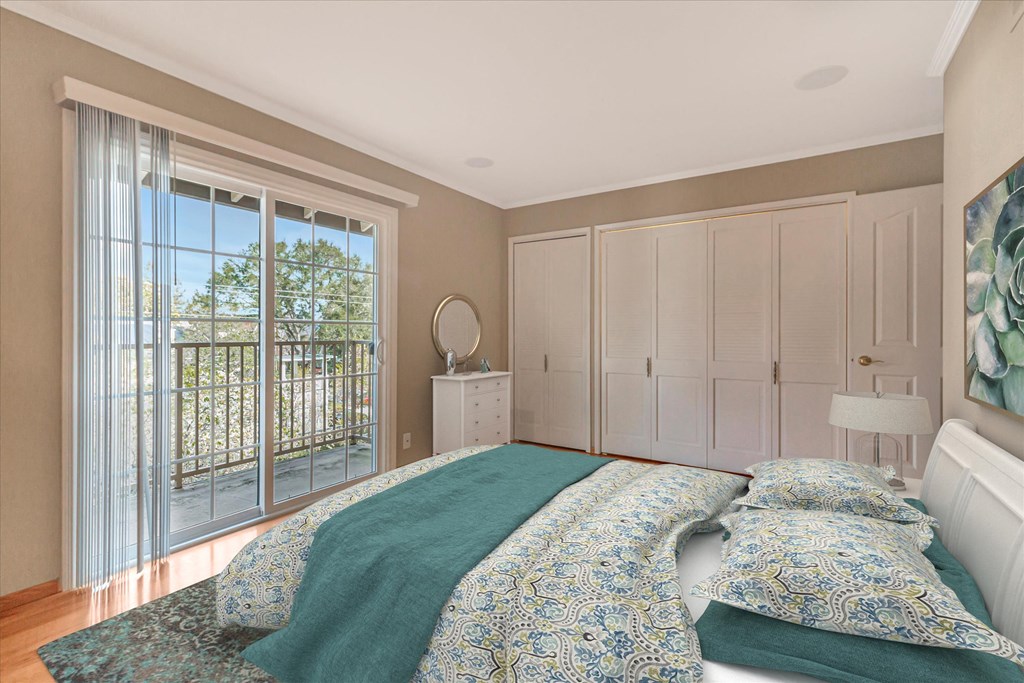 a bedroom with a bed and a sliding glass door