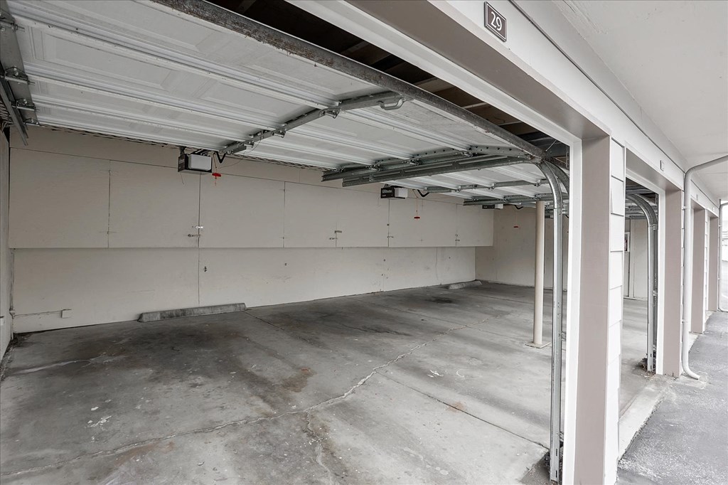 the inside of a garage with white walls and a garage door