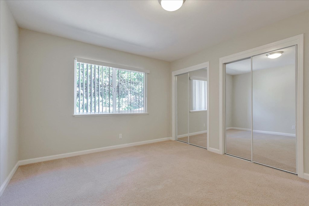 A room with a window and a sliding door.