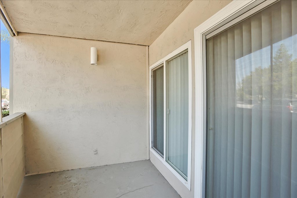 A room with a window and a wall socket.