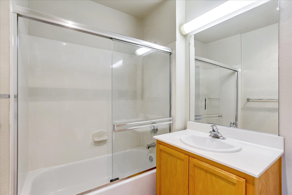 A white sink is on a counter in a bathroom.