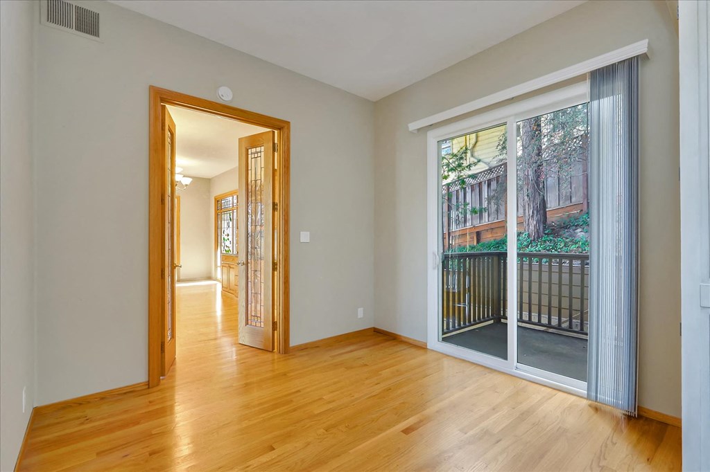 a living room with a large window and a door to a balcony