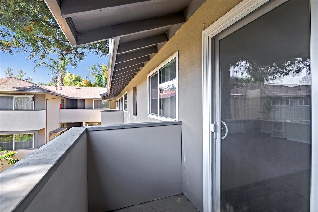 a balcony with a door to a patio