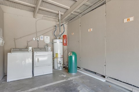 an empty garage with two washes and a boiler in it