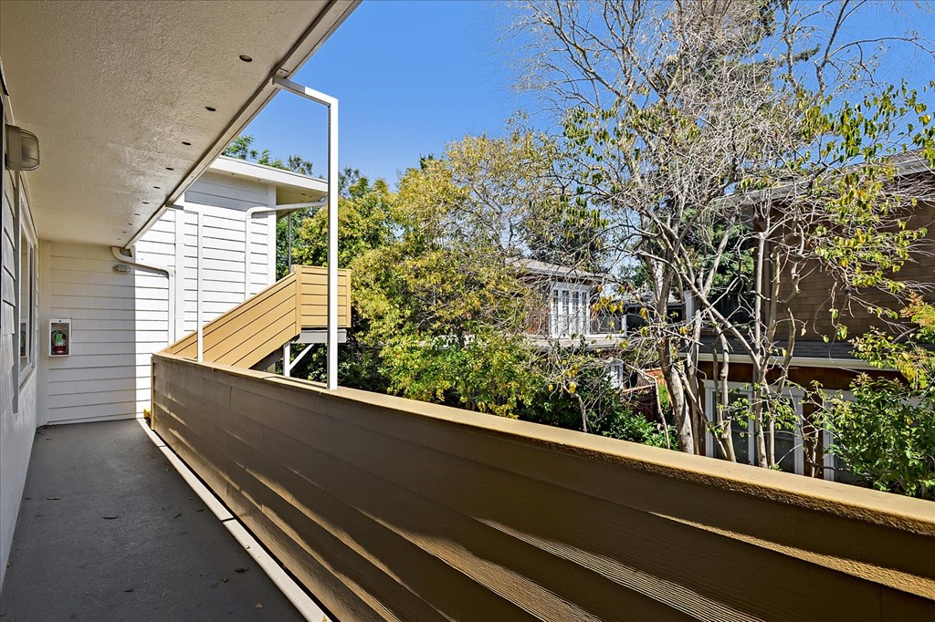 the deck has a view of the yard and the house
