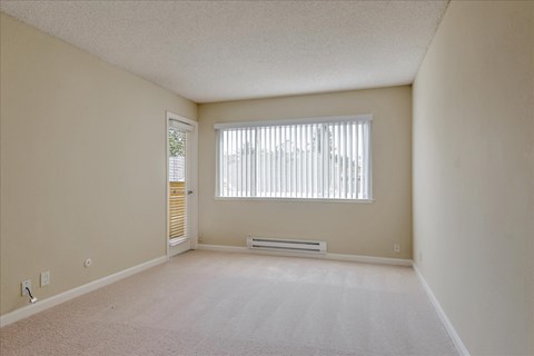 an empty living room with a large window