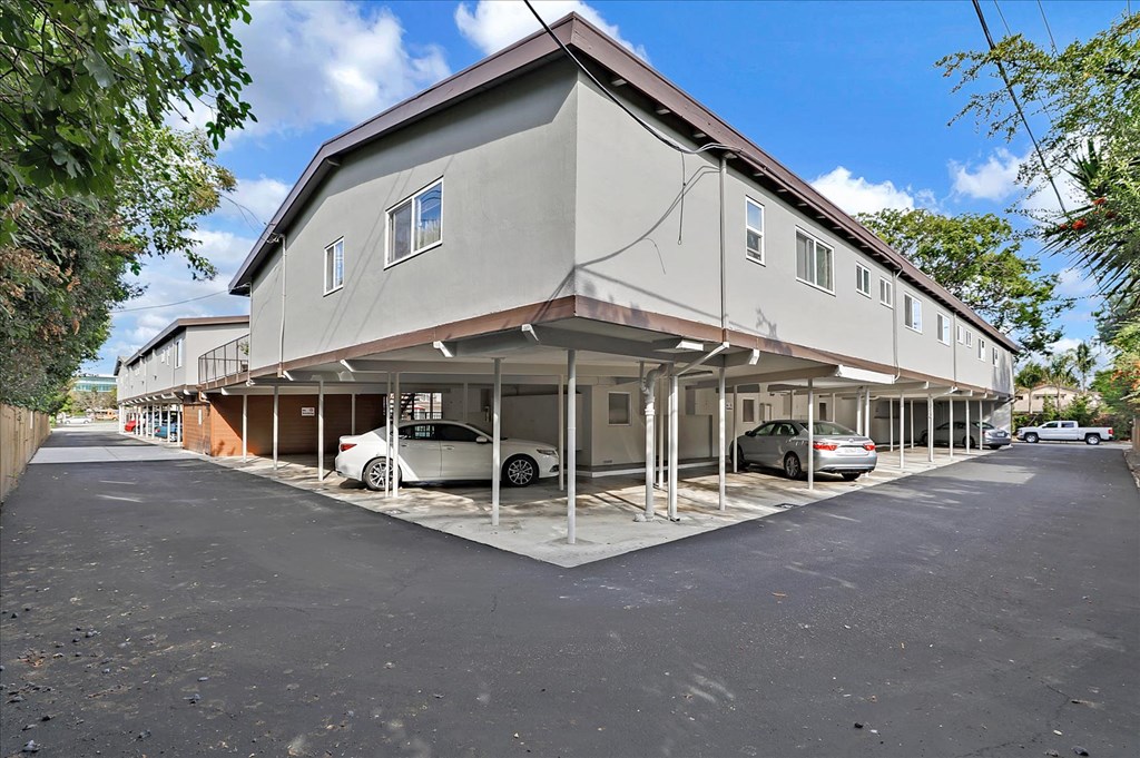 a large building with cars parked in front of it