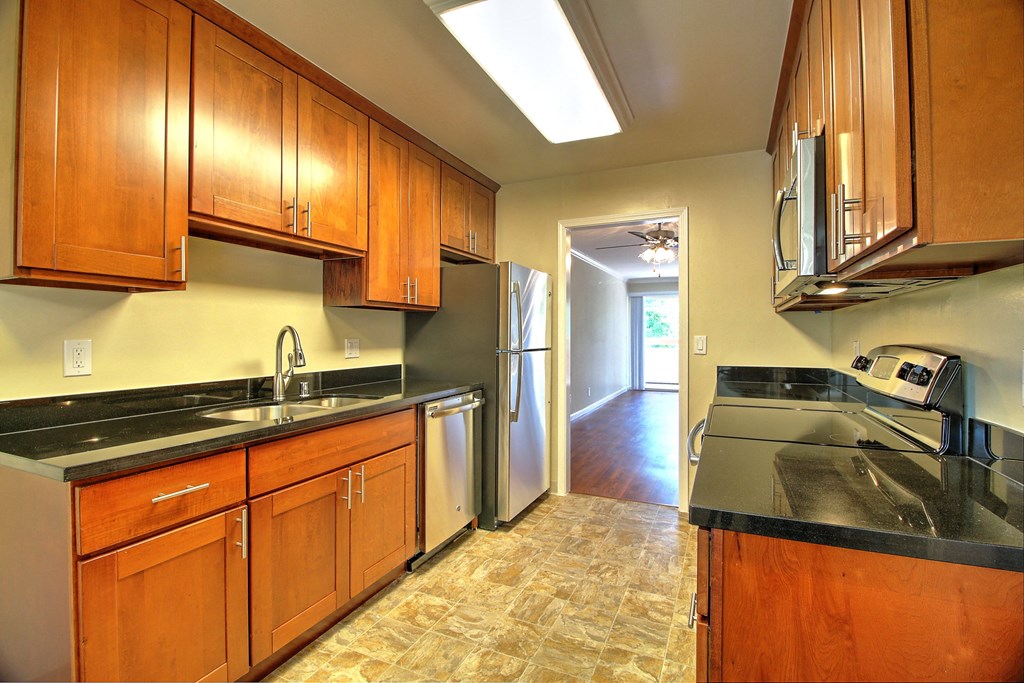 a kitchen with wooden cabinets and stainless steel appliances