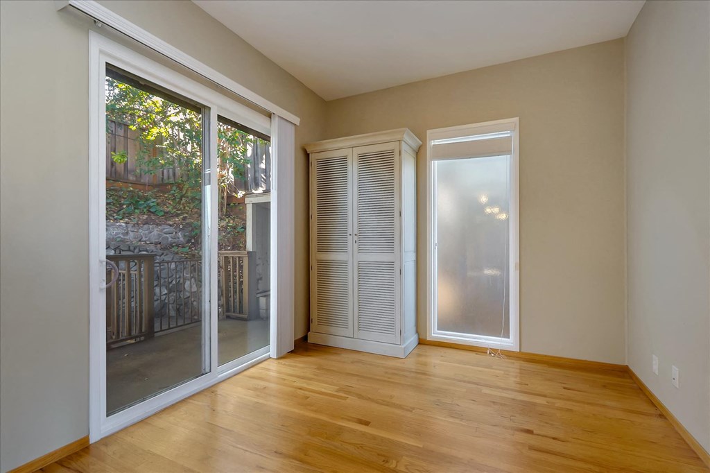 a living room with sliding glass doors and a wood floor
