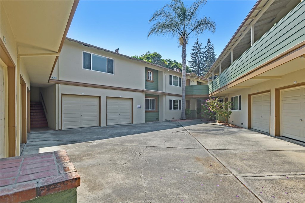 the driveway is in front of a row of garage doors