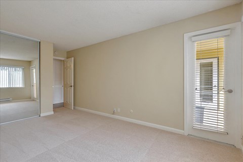 a spacious living room with a door to the bathroom