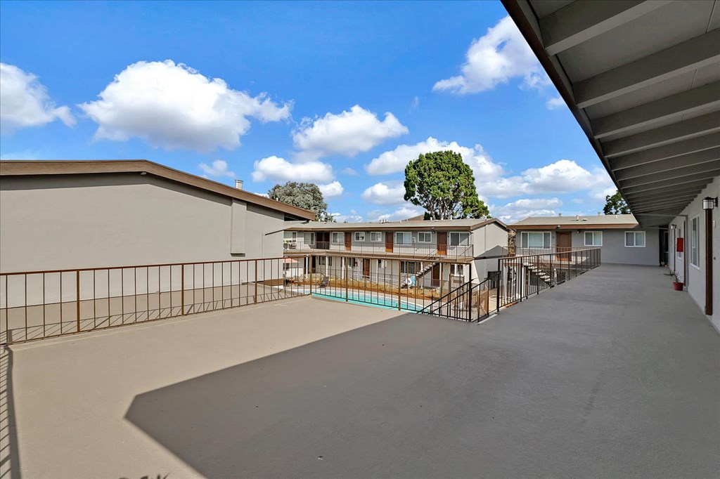 the view of a courtyard with a pool and buildings