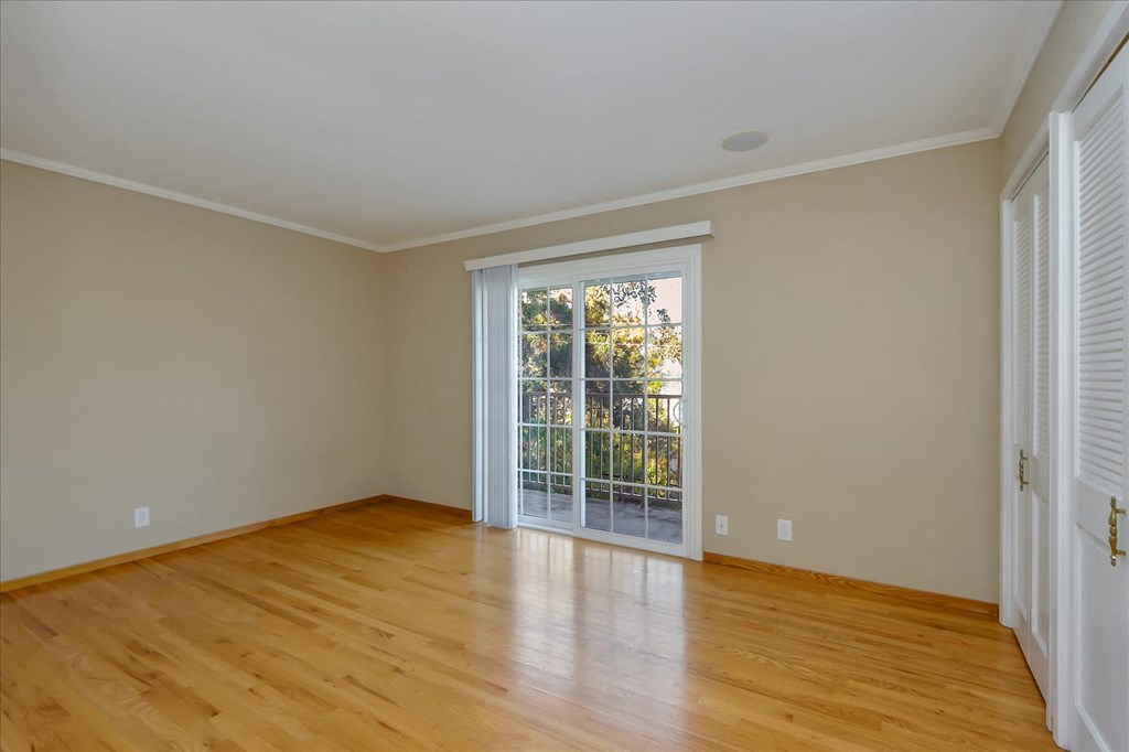 a living room with wood floors and a sliding glass door