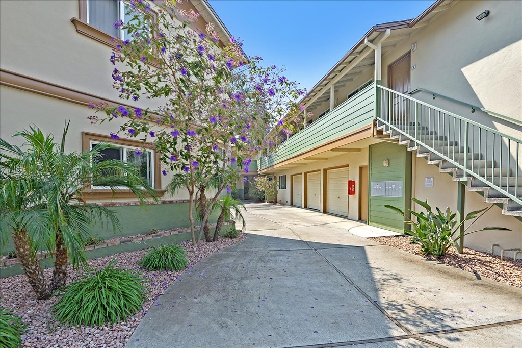 a sidewalk in front of a building with a staircase