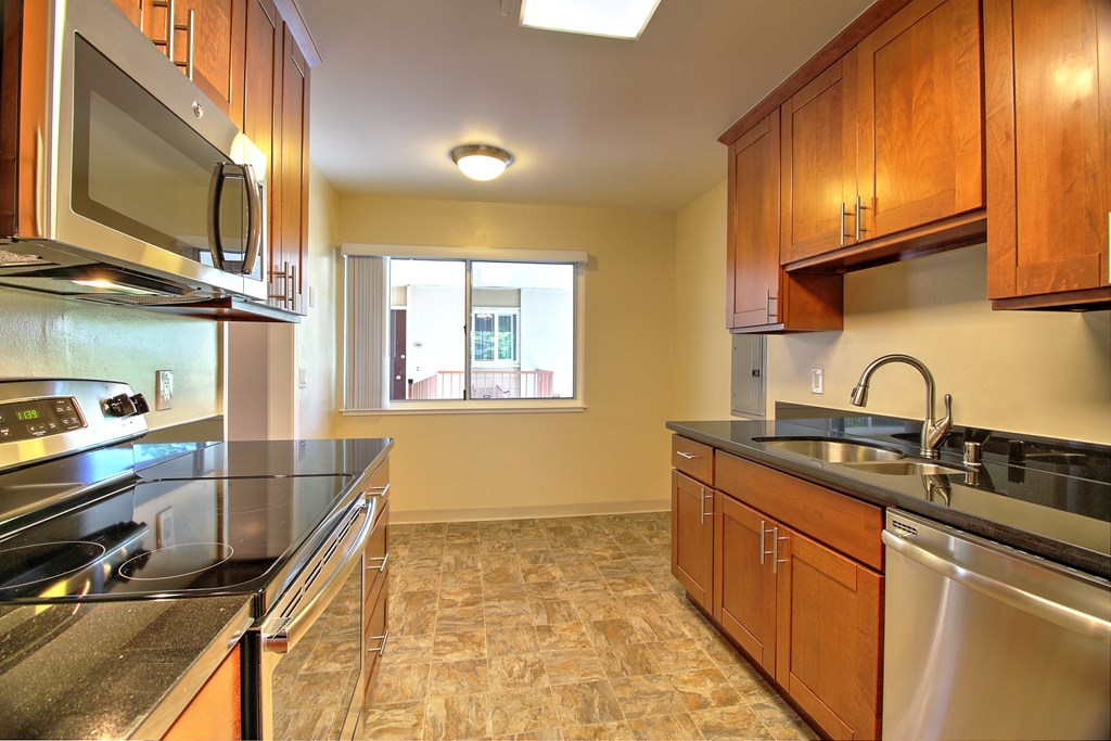 a kitchen with stainless steel appliances and wooden cabinets