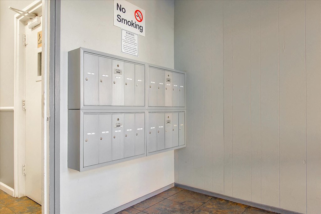 a locker room with lockers and a no smoking sign on the wall