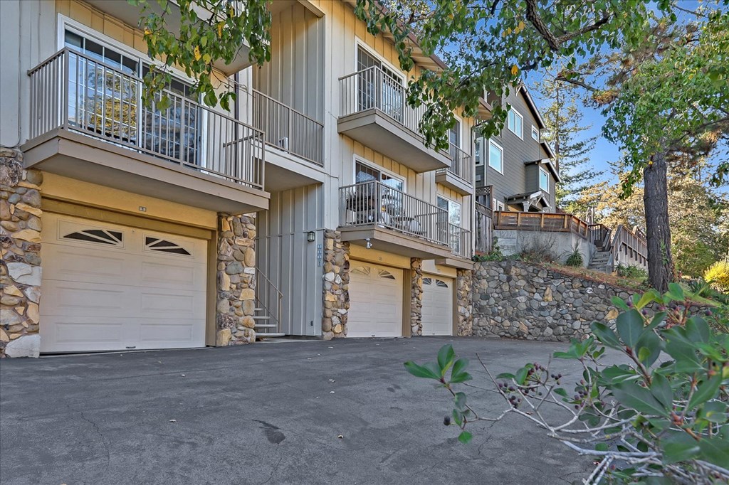 a pair of white garage doors in front of a building