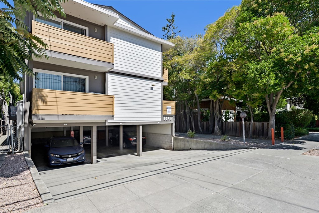 an apartment building with a car parked in a driveway