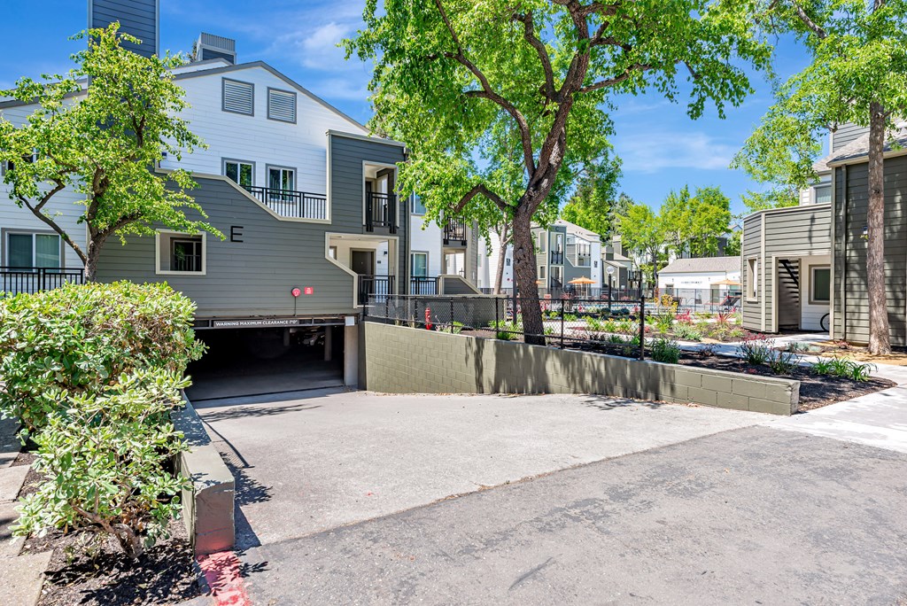 A modern house with a grey exterior and a driveway leading to the garage.