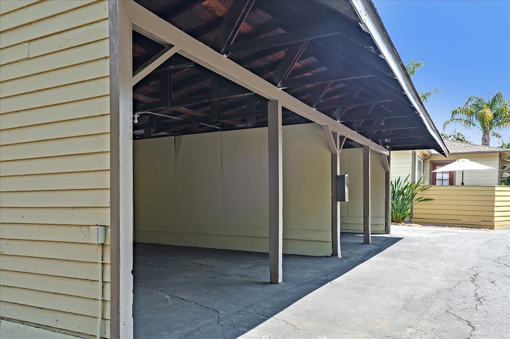 A garage with a wooden roof and tan walls.