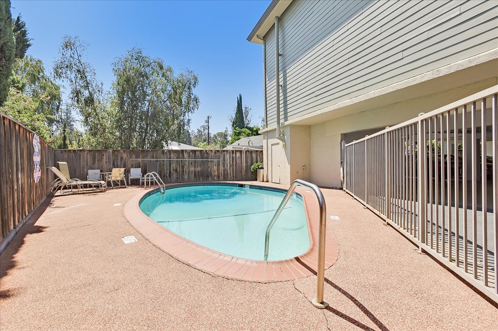 A small pool with a fence around it.