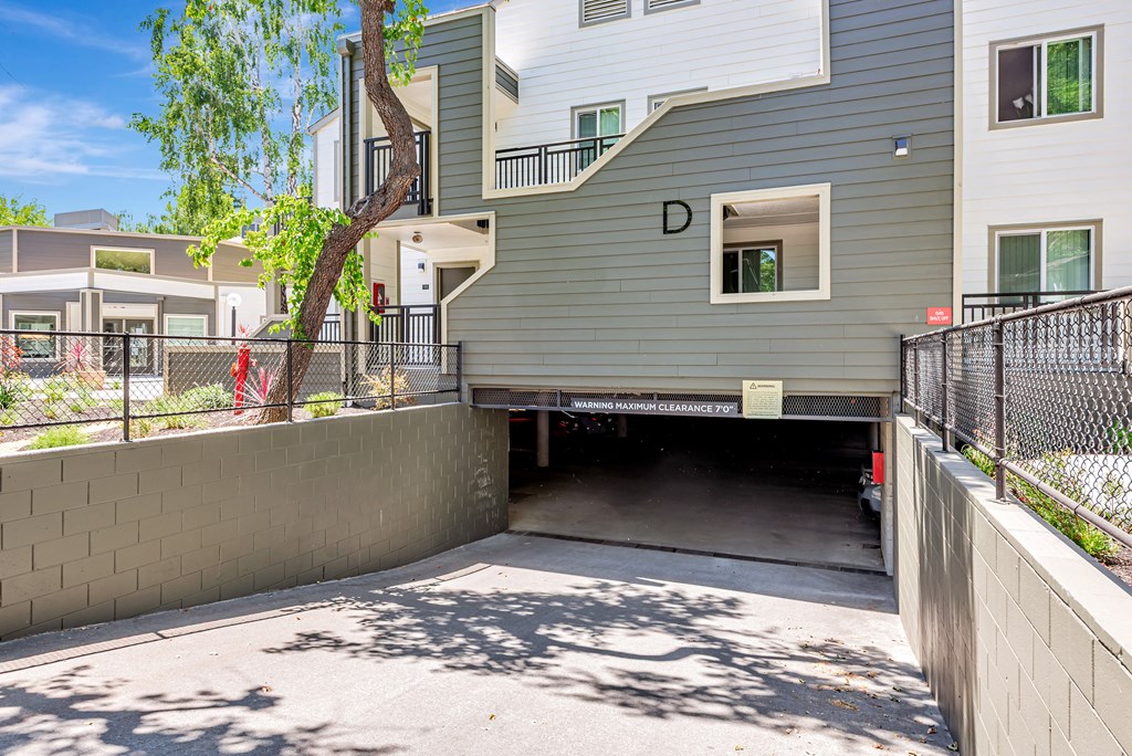 A modern two-story building with a garage under the letter D.