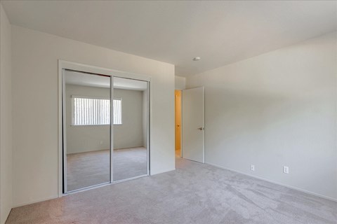 A room with a white wall and a carpeted floor.