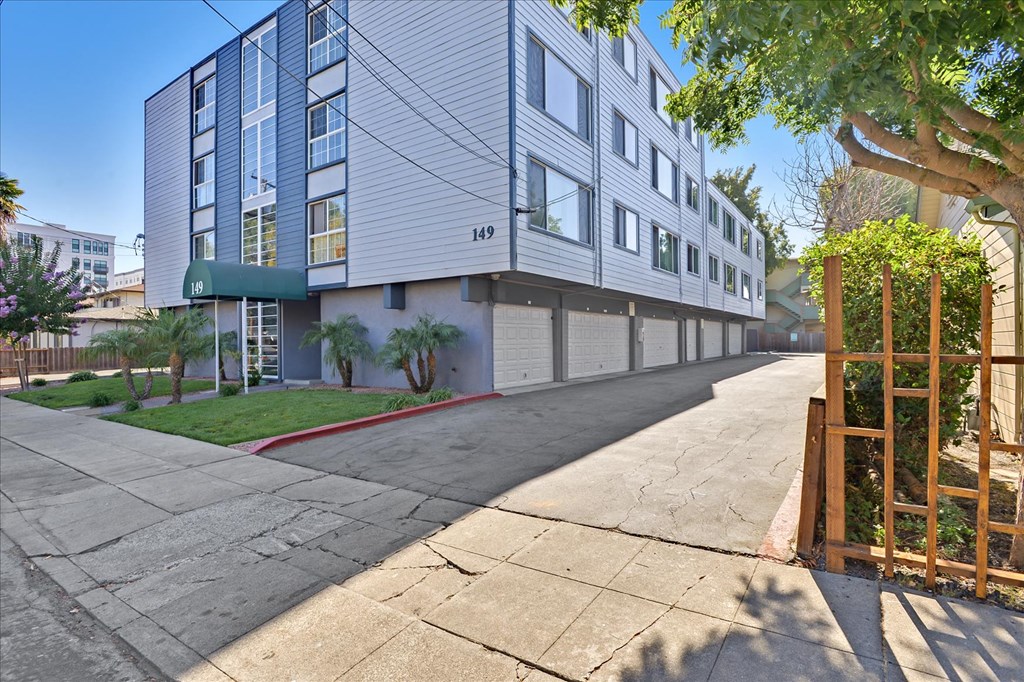 a street view of an apartment building with a sidewalk