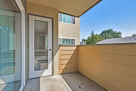 the front porch of a condo with a door to the patio