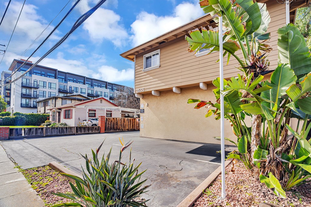 A building with a brown roof and a white pole in front of it.
