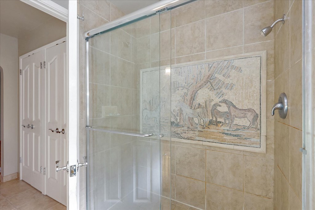 a large shower with a glass door in a bathroom
