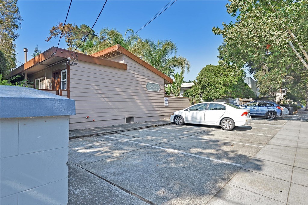 a house with a parking lot and a white car
