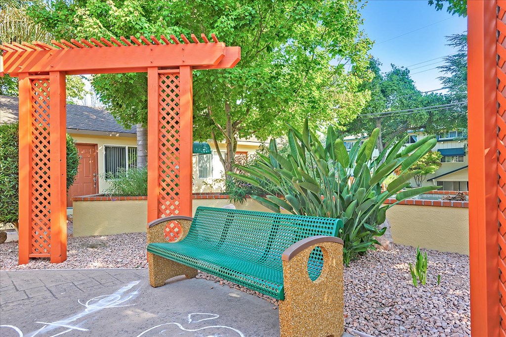 a bench sitting in front of a garden