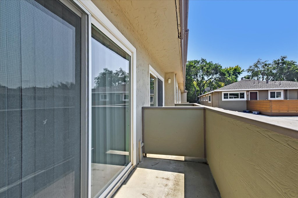 the outlook from the balcony of a home with large glass doors