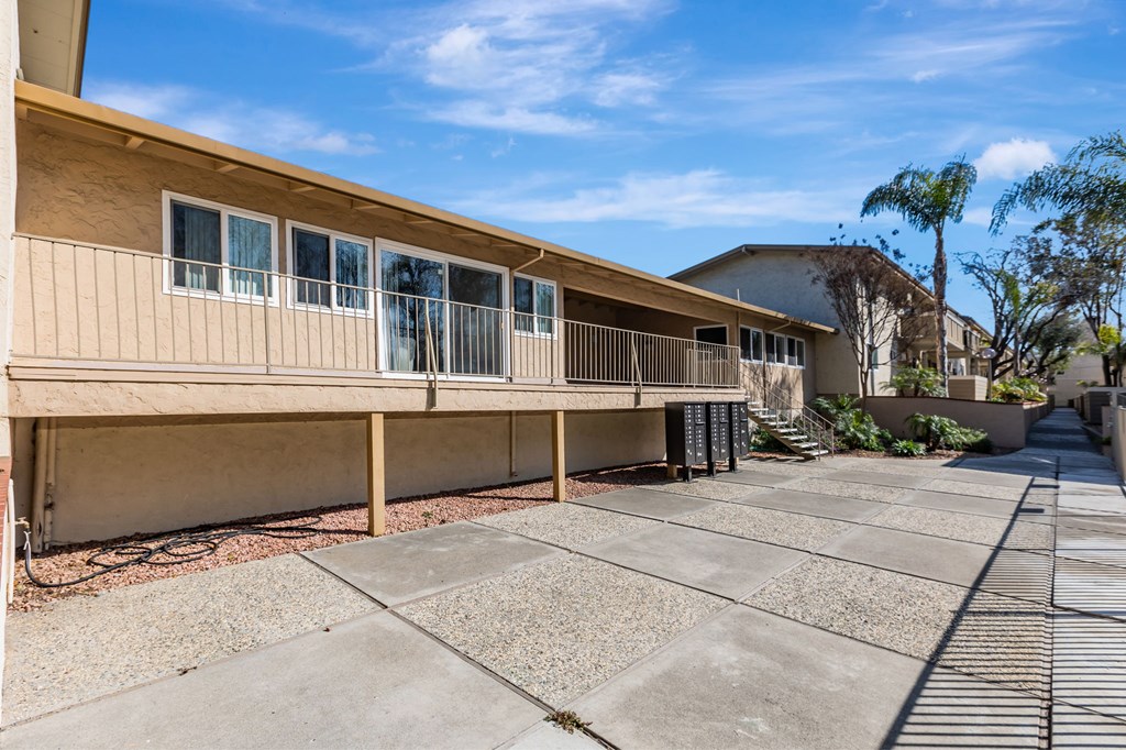 A sunny day at a residential complex with a clear blue sky.