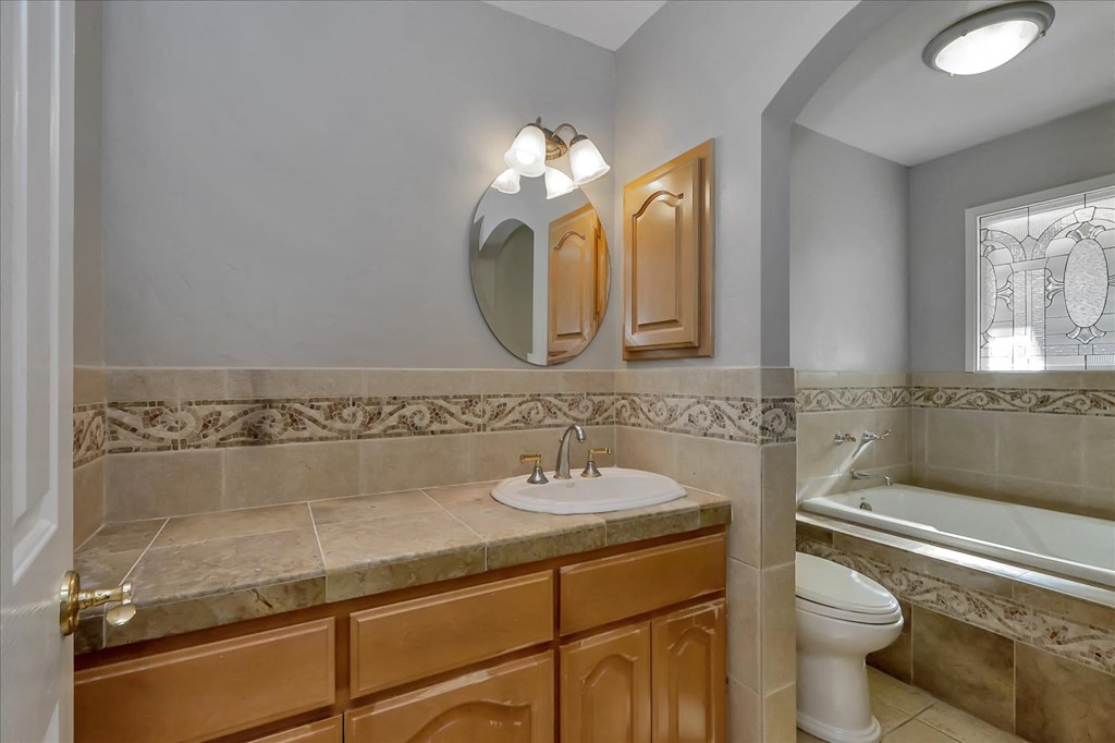 a bathroom with a sink and a toilet and a tub