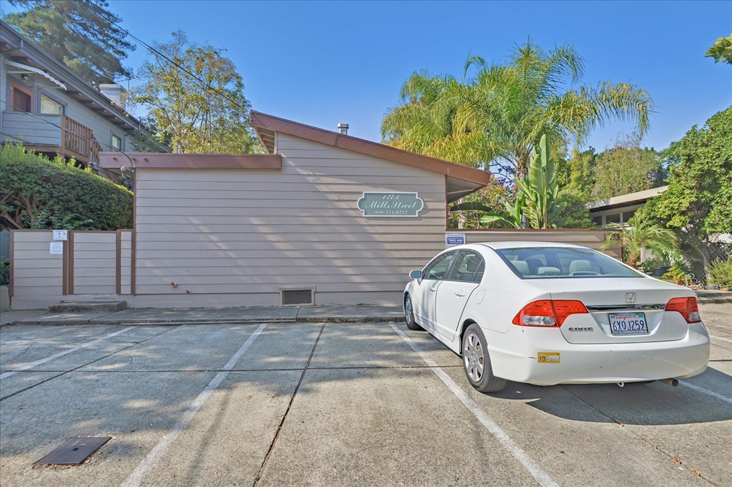 a car parked in a parking lot in front of a garage