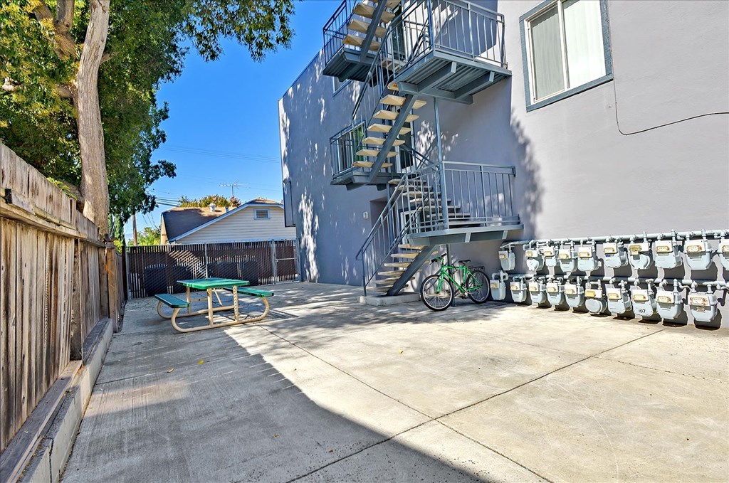 a patio with a bike parked in front of a building