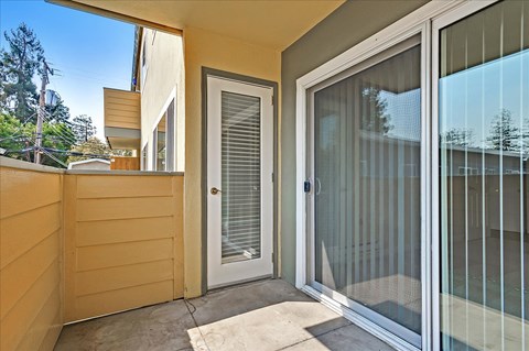 a patio outside of a home with a glass door