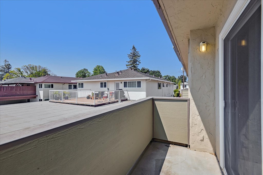 the view from the balcony of a home with a large deck