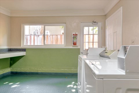 a kitchen with a washer and dryer and a window