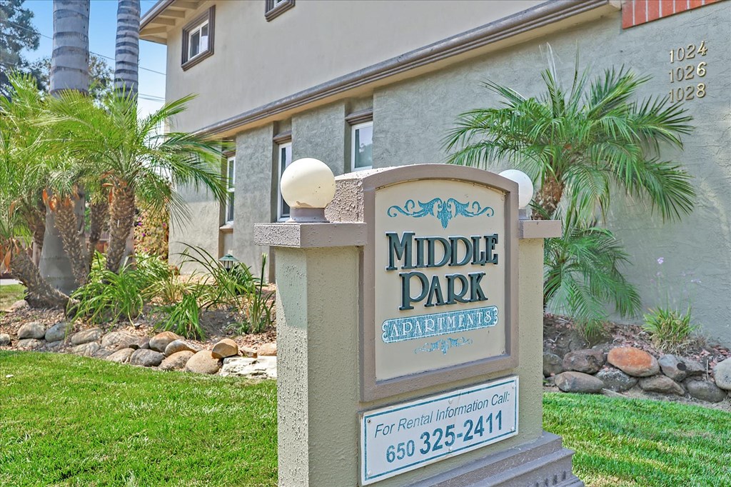 a middle park neighborhood sign in front of a house