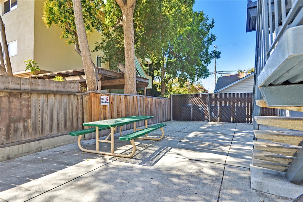 a picnic table in the back yard of a house